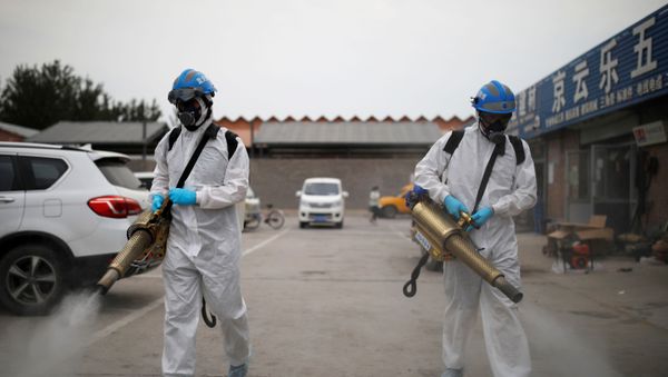 Volunteers from the Blue Sky Rescue team, in protective suits, disinfect the Nangong comprehensive market following a new outbreak of the coronavirus disease (COVID-19) in Beijing, China, June 18, 2020. Picture taken June 18, 2020. REUTERS/Carlos Garica Rawlins Volunteers from the Blue Sky Rescue team, in protective suits, disinfect the Nangong comprehensive market following a new outbreak of the coronavirus disease (COVID-19) in Beijing, China, June 18, 2020. Picture taken June 18, 2020. REUTERS/Carlos Garica Rawlins - Sputnik International