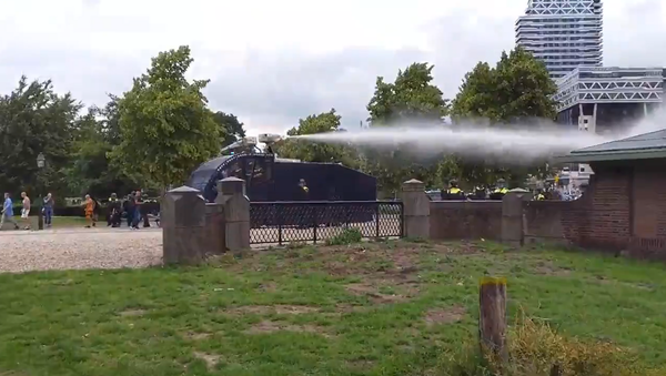 Police use a water cannon to disperse protesters gathered in Malieveld, the Hague on 21 June, 2020 - Sputnik International