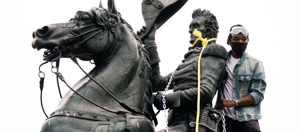 A protestors wraps chains and ropes around the statue of U.S. President Andrew Jackson during an attempt by protestors to pull the statue down in the middle of Lafayette Park in front of the White House during racial inequality protests in Washington, D.C., U.S., June 22, 2020 A protestors wraps chains and ropes around the statue of U.S. President Andrew Jackson during an attempt by protestors to pull the statue down in the middle of Lafayette Park in front of the White House during racial inequality protests in Washington, D.C., U.S., June 22, 2020 - Sputnik International