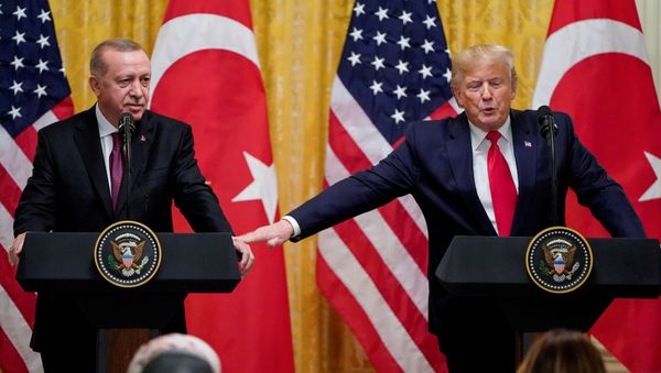 U.S. President Donald Trump reaches to Turkey's President Tayyip Erdogan during a joint news conference at the White House in Washington, U.S., November 13, 2019 U.S. President Donald Trump reaches to Turkey's President Tayyip Erdogan during a joint news conference at the White House in Washington, U.S., November 13, 2019 - Sputnik International