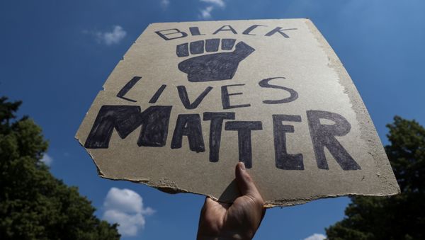 A placard is seen during a protest against police brutality and racial inequality in the aftermath of the death in Minneapolis police custody of George Floyd, at the Victory column in Berlin, Germany June 27, 2020. - Sputnik International