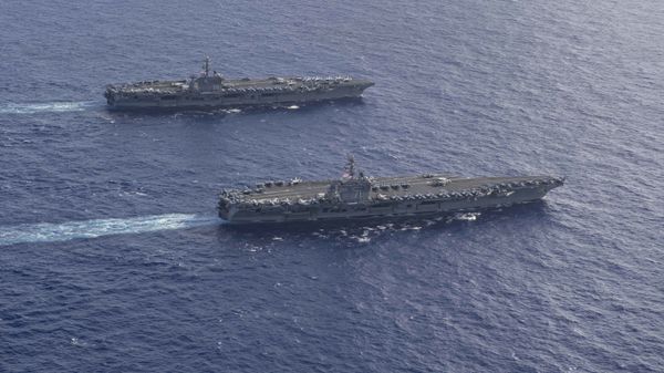 The Theodore Roosevelt Carrier Strike Group transits in formation with the Nimitz Carrier Strike Group while conducting dual carrier and airwing operations in the Philippine Sea June 23, 2020. - Sputnik International