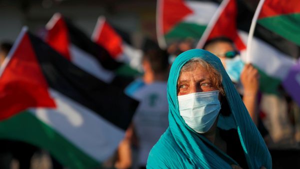 Peace activists take part in a protest against Israel's plan to annex parts of the Israeli-occupied West Bank, in the Palestinian town of Jericho June 27, 2020 Peace activists take part in a protest against Israel's plan to annex parts of the Israeli-occupied West Bank, in the Palestinian town of Jericho June 27, 2020 - Sputnik International