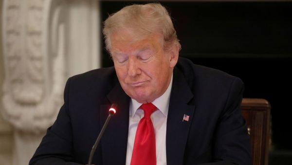 US President Donald Trump is using a mobile phone during a roundtable discussion on the reopening of small businesses in the State Dining Room at the White House in Washington, U.S., June 18, 2020. - Sputnik International