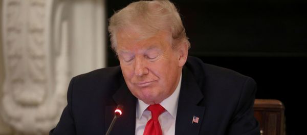 US President Donald Trump is using a mobile phone during a roundtable discussion on the reopening of small businesses in the State Dining Room at the White House in Washington, U.S., June 18, 2020. - Sputnik International
