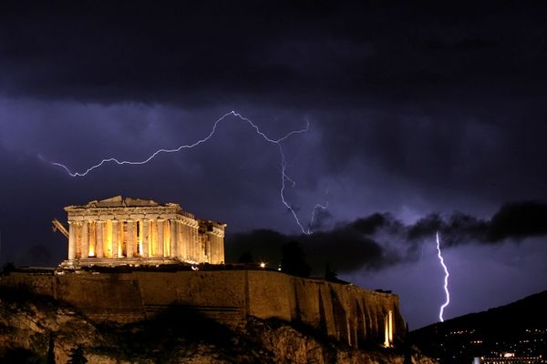 The ancient Greek Parthenon, a temple atop Acropolis hill overlooking Athens, is framed by lightning bolts during a thunderstorm that broke out in the Greek capital in October 2006 The ancient Greek Parthenon, a temple atop Acropolis hill overlooking Athens, is framed by lightning bolts during a thunderstorm that broke out in the Greek capital in October 2006 - Sputnik International
