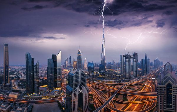 Dramatic Dubai sunset panoramic view of downtown with a lightning storm Dramatic Dubai sunset panoramic view of downtown with a lightning storm - Sputnik International