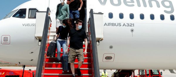 Passengers leave a Vueling plane upon their arrival at Palma de Mallorca airport on the Balearic Islands, Spain, June 13, 2020. Passengers leave a Vueling plane upon their arrival at Palma de Mallorca airport on the Balearic Islands, Spain, June 13, 2020. - Sputnik International