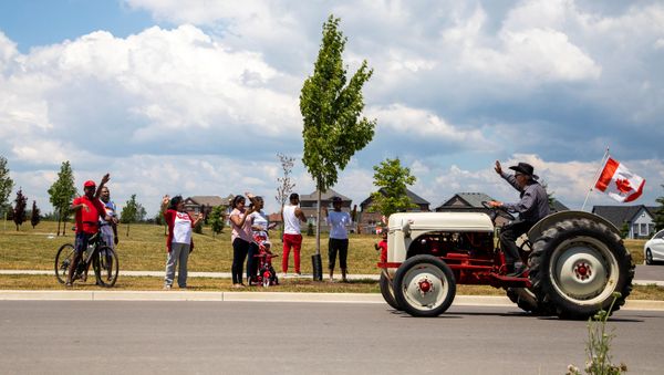People watch from the sidewalk as a drive-by parade makes its away around town, during Canada Day celebrations in Newcastle, Ontario, Canada July 1, 2020. People watch from the sidewalk as a drive-by parade makes its away around town, during Canada Day celebrations in Newcastle, Ontario, Canada July 1, 2020. - Sputnik International