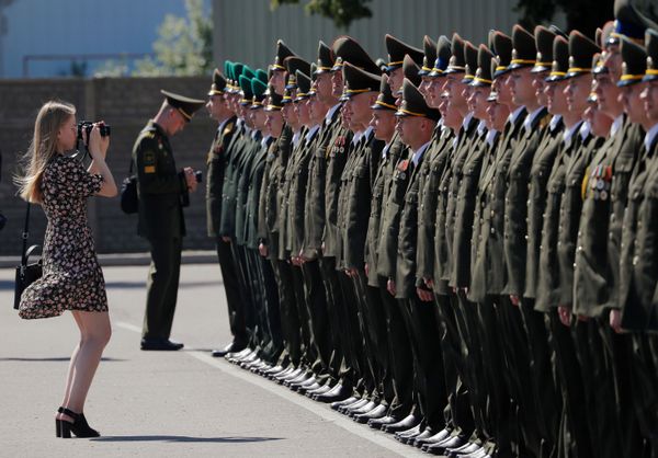 A woman takes photos of graduates as they stand in line while receiving diplomas at the Military Academy of Belarus, amid the coronavirus disease (COVID-19) outbreak in Minsk, Belarus June 27, 2020 A woman takes photos of graduates as they stand in line while receiving diplomas at the Military Academy of Belarus, amid the coronavirus disease (COVID-19) outbreak in Minsk, Belarus June 27, 2020 - Sputnik International