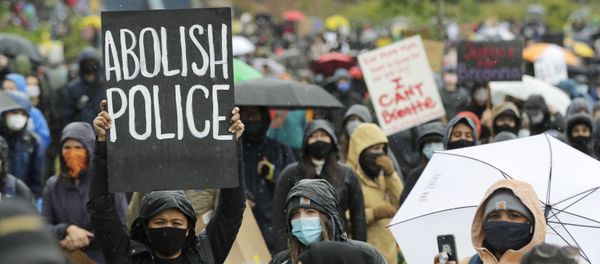 A protester holds a sign that reads Abolish Police during a Silent March against racial inequality and police brutality that was organized by Black Lives Matter Seattle-King County, Friday, June 12, 2020, in Seattle A protester holds a sign that reads Abolish Police during a Silent March against racial inequality and police brutality that was organized by Black Lives Matter Seattle-King County, Friday, June 12, 2020, in Seattle - Sputnik International
