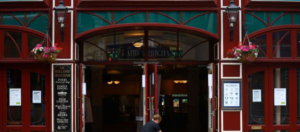 A staff member opens the doors of The Holland Tringham Wetherspoons pub - Sputnik International