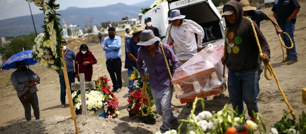 Cemetery workers carry the coffin containing the body of Juana, 50, who died of the coronavirus disease (COVID-19) next to a grave at the Xico cemetery on the outskirts of Mexico City, Mexico, June 10, 2020.  - Sputnik International
