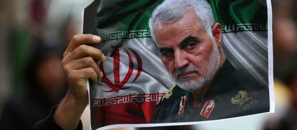 An Iranian holds a picture of late General Qassem Soleimani, head of the elite Quds Force, who was killed in an air strike at Baghdad airport, as people gather to mourn him in Tehran, Iran January 4, 2020. An Iranian holds a picture of late General Qassem Soleimani, head of the elite Quds Force, who was killed in an air strike at Baghdad airport, as people gather to mourn him in Tehran, Iran January 4, 2020. - Sputnik International