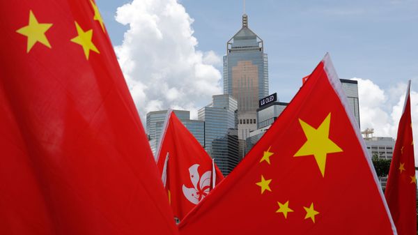 Buildings are seen above Hong Kong and Chinese flags, as pro-China supporters celebration after China's parliament passes national security law for Hong Kong, in Hong Kong, China June 30, 2020. REUTERS/Tyrone Siu - Sputnik International