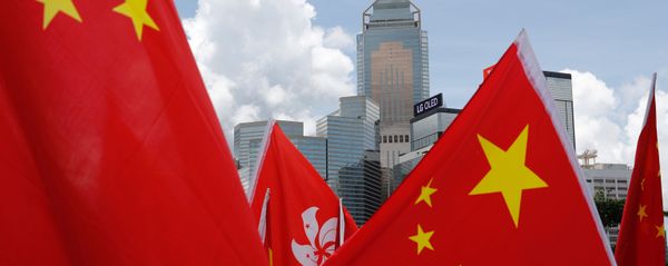 Buildings are seen above Hong Kong and Chinese flags, as pro-China supporters celebration after China's parliament passes national security law for Hong Kong, in Hong Kong, China June 30, 2020. REUTERS/Tyrone Siu Buildings are seen above Hong Kong and Chinese flags, as pro-China supporters celebration after China's parliament passes national security law for Hong Kong, in Hong Kong, China June 30, 2020. REUTERS/Tyrone Siu - Sputnik International