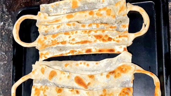 Amidst soaring COVID19 cases in #Madurai, a restaurant chain introduces 'face mask' parotta, 'corona' rava dosa & 'corona' bonda - Sputnik International