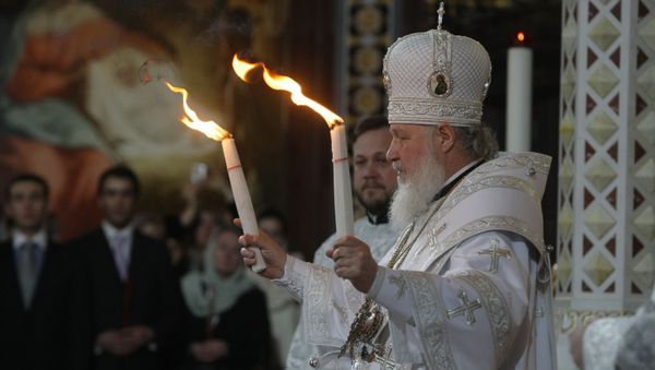 Patriarch Kirill of Moscow and All Russia handed the Holy Fire delivered from Jerusalem to all those thousands of faithful gathered at Moscow's Christ the Savior Cathedral on the Easter Night - Sputnik International