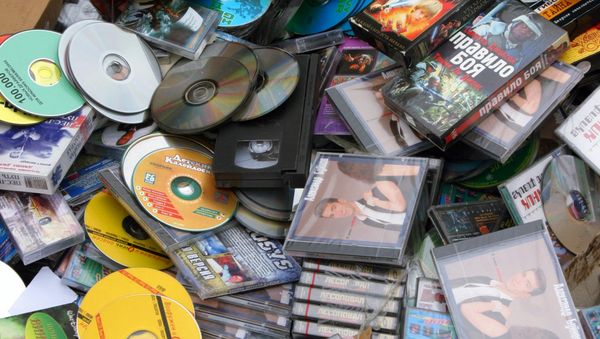 Bulldozing heaped counterfeit products, CD and DVD disks Bulldozing heaped counterfeit products, CD and DVD disks - Sputnik International