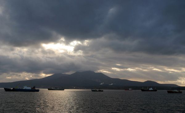 Kunashir Island, Kuril Islands. Russian fishing vessels in the foreground Kunashir Island, Kuril Islands. Russian fishing vessels in the foreground - Sputnik International