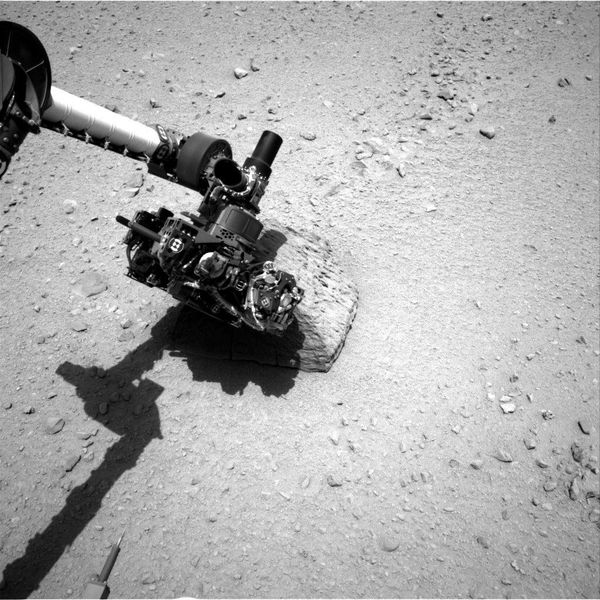 This image shows the robotic arm of NASA's Mars rover Curiosity with the first rock touched by an instrument on the arm. The rover's right Navigation Camera (Navcam) took this image during the 46th Martian day, or sol, of the mission (Sept. 22, 2012) This image shows the robotic arm of NASA's Mars rover Curiosity with the first rock touched by an instrument on the arm. The rover's right Navigation Camera (Navcam) took this image during the 46th Martian day, or sol, of the mission (Sept. 22, 2012) - Sputnik International