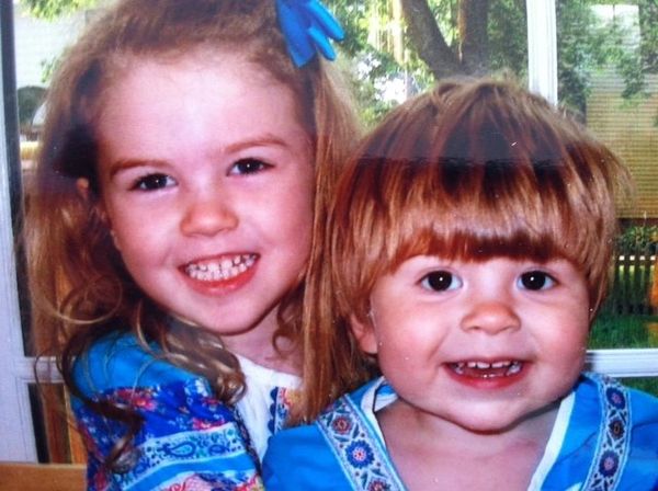 Russian adoptee Yana Herzog, right, and her older sister, Caroline, wear traditional Russian outfits. - Sputnik International