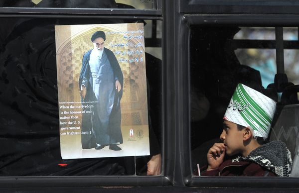 A city bus navigating traffic in Tehran earlier this month, adorned with an image of Ayatollah Khomeini. - Sputnik International