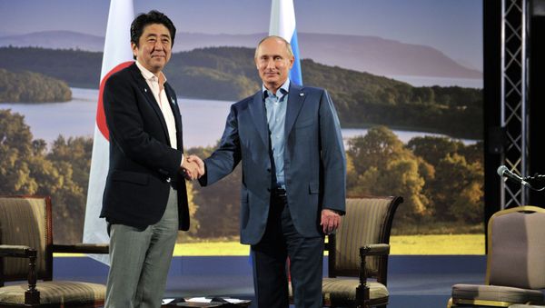 Japanese Prime Minister Shinzo Abe and Russian President Vladimir Putin shake hands before their meeting during the G8 Summit at Lough Erne in Enniskillen, Northern Ireland, June 17, 2013 Japanese Prime Minister Shinzo Abe and Russian President Vladimir Putin shake hands before their meeting during the G8 Summit at Lough Erne in Enniskillen, Northern Ireland, June 17, 2013 - Sputnik International