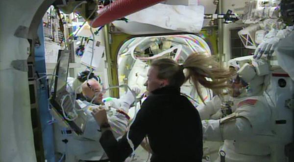 ISS crew member Karen Nyberg helps astronaut Luca Parmitano remove his spacesuit after a leak in his helmet caused a spacewalk to be cut short on July 16. - Sputnik International