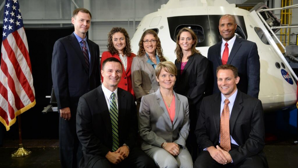 Members of NASA's newest astronaut class pose with an Orion capsule at NASA's space center in Houston on Tuesday. - Sputnik International