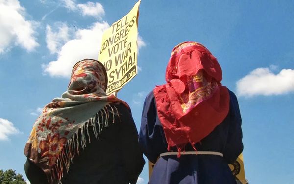 Young women from Iraq and Afghanistan join the protest in Washington against US military intervention in Syria on Saturday, Sept. 7. - Sputnik International
