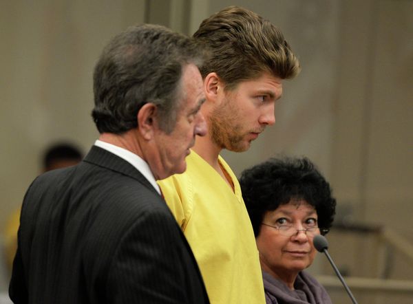 Colorado Avalanche goalie Semyon Varlamov, standing between his attorney Jack Rotole, left, and a Russian interpreter, appears in court in Denver on Thursday, Oct. 31, 2013 - Sputnik International