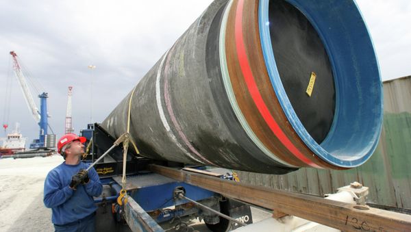 A worker preparing the pipes for the construction of the Nord Stream pipeline for their shipment to the transportation vessel. - Sputnik International