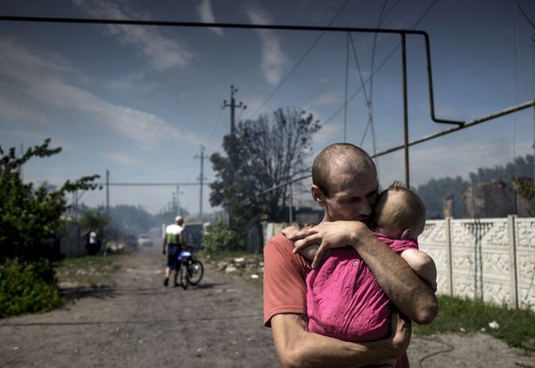 Local residents in the village of Luganskaya after the Ukrainian armed forces' air attack. - Sputnik International