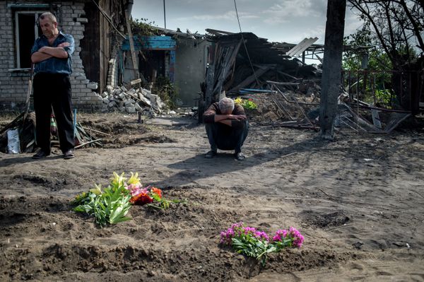 The relatives and friends of Vladimir Yermilov and his son, Vanya, both of whom were killed in a Ukrainian military artillery strike on the village of Luganskaya - Sputnik International