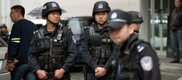 Armed policemen stand guard near the site of an explosion in Urumqi, northwest China's Xinjiang region, Thursday, May 22, 2014 Armed policemen stand guard near the site of an explosion in Urumqi, northwest China's Xinjiang region, Thursday, May 22, 2014 - Sputnik International