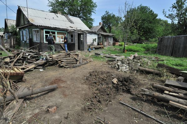 A crater formed after the territory of a private house in the town of Donetsk, Rostov-on-Don Region, was hit by one of high-explosive shells fired at the town from the Ukrainian territory (File). - Sputnik International