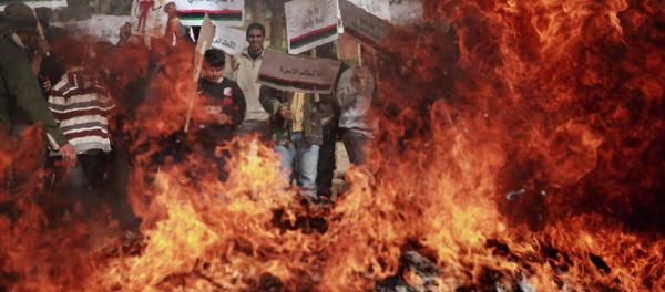 Benghazi residents burn portraits of Muammar Gaddafi, posters with his quotes and his Green Book (File). - Sputnik International