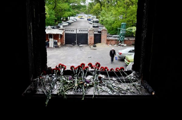 Flowers on a broken window in memory of the people killed by fire in the Trade Unions House on Odessa's Kulikovo Field Square. - Sputnik International