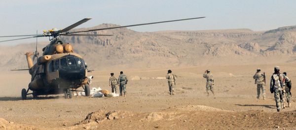 Afghan Border Police members and Kandahar Air Wing pilots offload humanitarian aid from an Afghan Air Force Mi-17 helicopter Afghan Border Police members and Kandahar Air Wing pilots offload humanitarian aid from an Afghan Air Force Mi-17 helicopter - Sputnik International