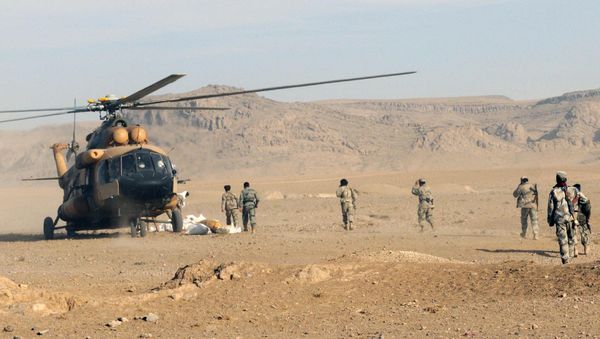 Afghan Border Police members and Kandahar Air Wing pilots offload humanitarian aid from an Afghan Air Force Mi-17 helicopter Afghan Border Police members and Kandahar Air Wing pilots offload humanitarian aid from an Afghan Air Force Mi-17 helicopter - Sputnik International